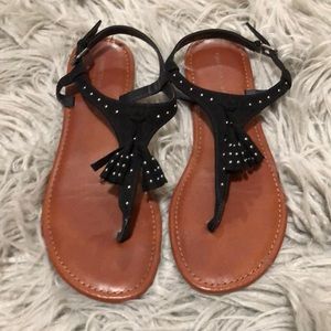 Black thong sandals with tassels and small studs